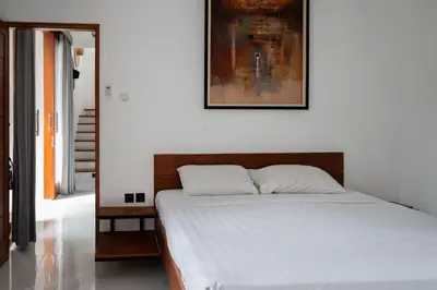 a bedroom with a bed with a picture on the wall at Villa Manis with a private pool in Nusa Dua in Nusa Dua