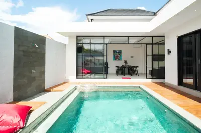 a swimming pool in the backyard of a house at Stylish Umalas 2BR Villa With Private Pool in Kerobokan
