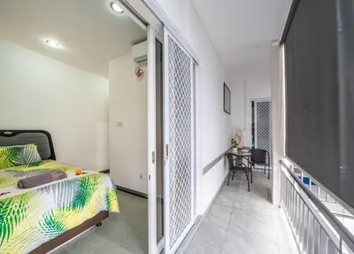 a bedroom with a bed and a balcony at KUTA - 3 Bedroom Private Pool Villa on Jl Mataram! in Kuta