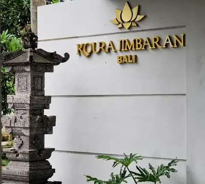 a sign for a hotel in bali at Koura Jimbaran in Badung