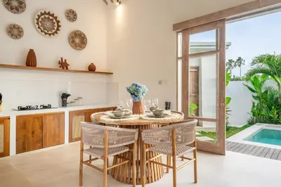 a kitchen and dining room with a table and chairs at Bambola - Stunning Luxury Villa in Kerobokan in Canggu