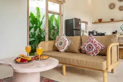 a living room with a couch and a table at Bambola - Stunning Luxury Villa in Kerobokan in Canggu