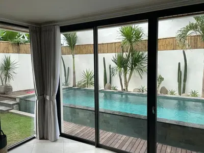 a view of a swimming pool from a house at Cozy 3 Bedrooms Villa Umalas in Kerobokan