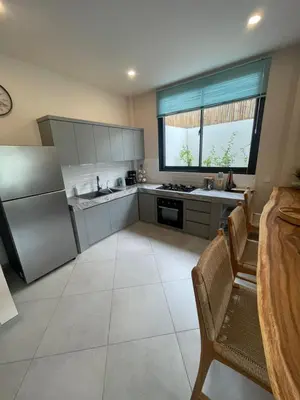 a kitchen with stainless steel appliances and a large window at Cozy 3 Bedrooms Villa Umalas in Kerobokan