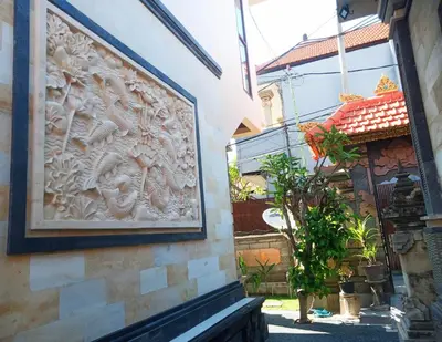 a wall with a picture on the side of a building at Nyoman19 Guest House in Seminyak