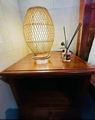 a lamp sitting on top of a wooden table at Nyoman19 Guest House in Seminyak
