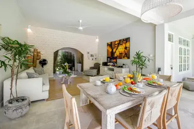 a dining room with a table with fruit on it at Villa Lodek Deluxe in Seminyak