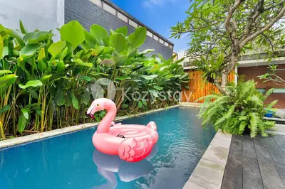 a pink inflatable flamingo in a swimming pool at Bamila Villa by Kozystay - Umalas in Canggu
