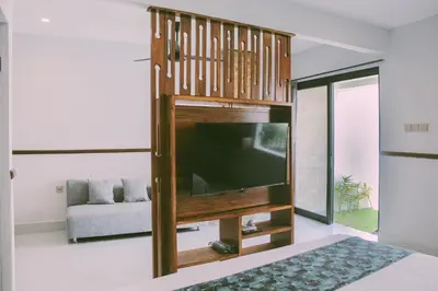 a living room with a flat screen tv at Sejati Villas - Petitenget in Seminyak