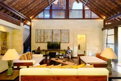 a living room with white couches and a tv at Villa Jepun Seminyak in Canggu