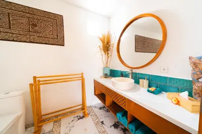 a bathroom with a sink and a mirror at Villa Kembar in Seminyak