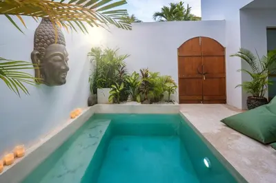 a swimming pool in a villa with a swimming pool at Villa Kembar in Seminyak