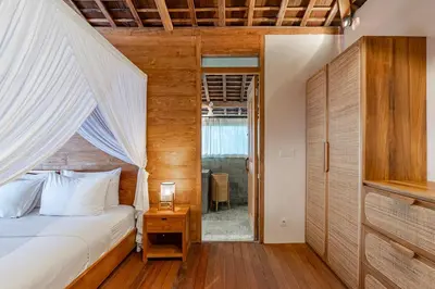 a bedroom with a bed with a white canopy at Villa Madah - Secluded & Romantic Retreat 1BR Near Umalas with Private Pool & View in Kerobokan