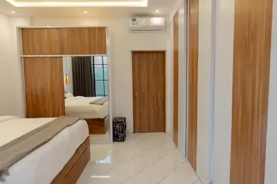 a hotel room with a bed and a mirror at Cozy Seminyak Loft 360 Sweet in Seminyak