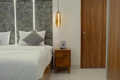 a bedroom with a bed and a nightstand with a bed sidx sidx at Cozy Seminyak Loft 3 Bedroom Private Villa in Seminyak