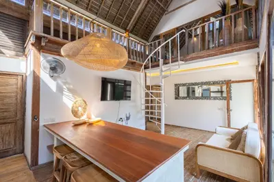 a living room with a table and a couch at Villa Vintage 3 in Canggu