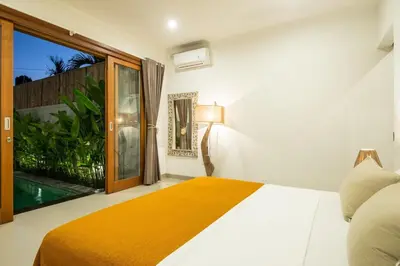 a bedroom with a bed and a large window at Canggu - Villa Romy - 2 Bedrooms - Private Pool in Kerobokan