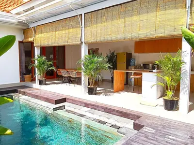 a backyard with a swimming pool and a house at Canggu - Villa Romy - 2 Bedrooms - Private Pool in Kerobokan