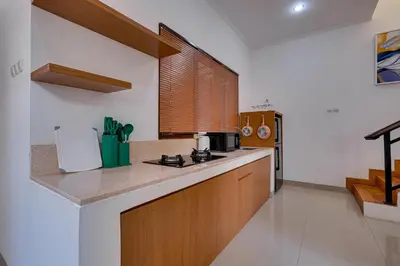 a kitchen with a counter and a stove top oven at Villa Boswellia Seminyak near Double Six Beach in Seminyak