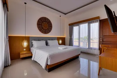 a bedroom with a large bed and a piano at Villa Boswellia Seminyak near Double Six Beach in Seminyak