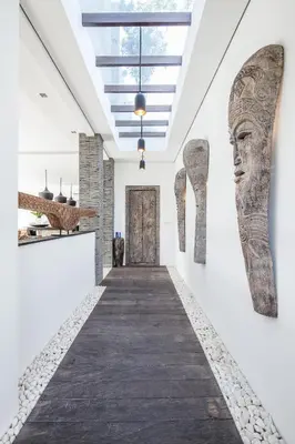 a hallway of a building with artifacts on the wall at Villa Elisa in Canggu