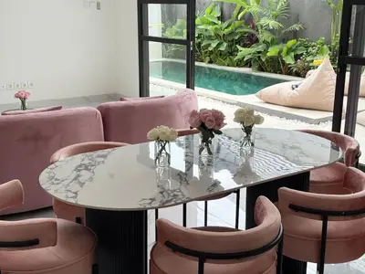 a dining room with a table and chairs and a pool at LUX 2 Bed Villa - Berawa in Canggu