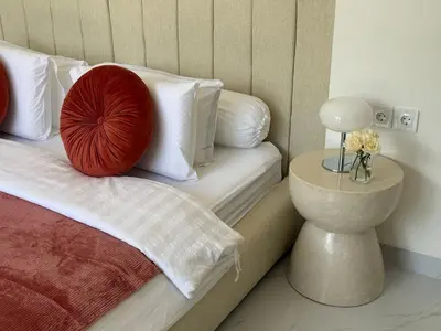 a bedroom with a bed with a red pillow on it at LUX 2 Bed Villa - Berawa in Canggu