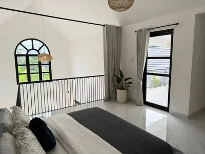 a white bedroom with a bed and a window at LUX 2 Bed Villa - Berawa in Canggu