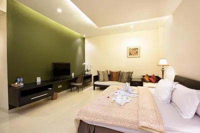 a hotel room with a bed and a tv at InKuta Residence and Villa in Seminyak