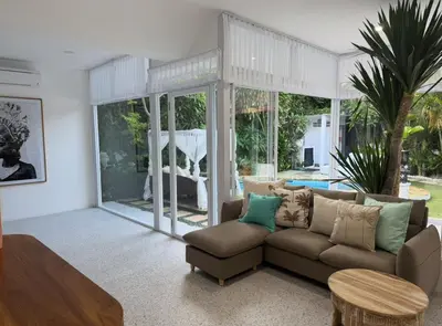 a living room with a couch and a table at White Sands Private Villa in Seminyak