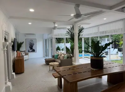 a living room with a table and a couch at White Sands Private Villa in Seminyak