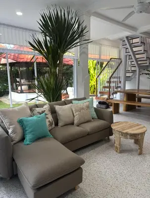 a living room with a couch and a table at White Sands Private Villa in Seminyak