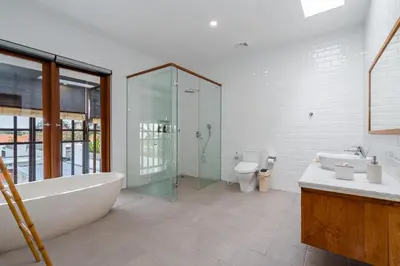 a bathroom with a tub and a shower and a toilet at Beta Stay and Surf in Canggu