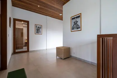 a hallway with white walls and a box on the floor at Beta Stay and Surf in Canggu