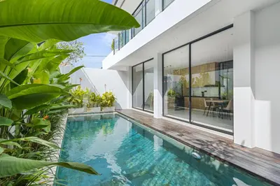 an infinity pool in the backyard of a house at New 3 BR Luxury Villa in Umalas in Canggu