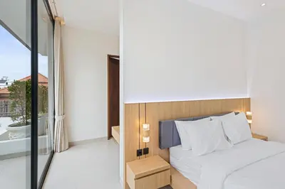 a bedroom with a bed and a balcony at New 3 BR Luxury Villa in Umalas in Canggu