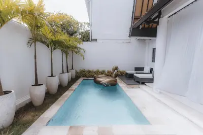 a swimming pool with a ball in the middle at Villa Manis Kecil in Seminyak