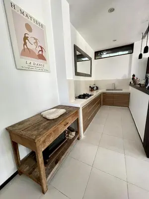 a bathroom with a wooden bench and a sink at Villa Eden - Seminyak in Seminyak