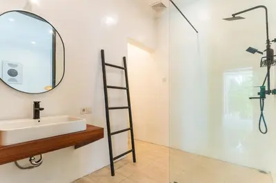 a bathroom with a sink and a mirror at Villa Nirvana Seminyak in Seminyak