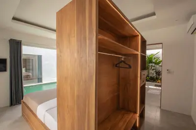 a bedroom with a wooden partition with a bed in it at Villa Yolanda - Seminyak Beach in Seminyak
