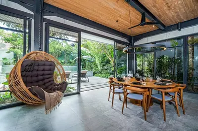 a dining room with a swing chair and a table at Family Luxury 5bd Villa Parking X Walk 2 Potato Head in Seminyak