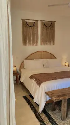 a bedroom with a large bed with curtains at Villa Hope Bali in Kerobokan