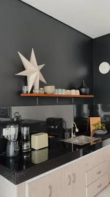 a kitchen with a black counter top with a star on the wall at Villa Hope Bali in Kerobokan