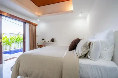 a bedroom with a bed with a view of the ocean at Villa Ullah - 2 Bedroom with a Private Pool in Canggu