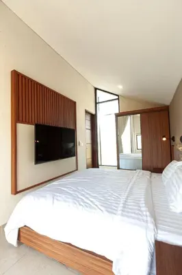 a bedroom with a large bed with a flat screen tv at Yearly Rent Seminyak Huis19 Villa in Seminyak