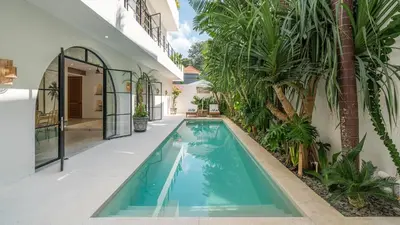 a swimming pool in the middle of a house at Villa Unna in Canggu by Elite Havens in Canggu