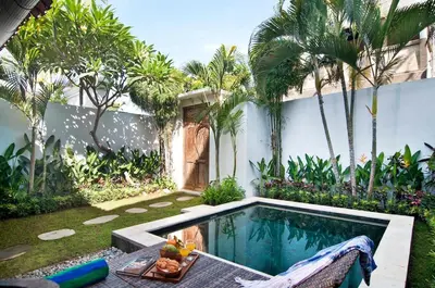 a backyard with a swimming pool and a table with fruit on it at AMAZING 1 BR Villa Private Pool walk to beach in Seminyak