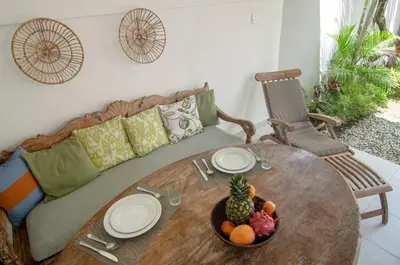 a wooden table with a bowl of fruit on a couch at AMAZING 1 BR Villa Private Pool walk to beach in Seminyak