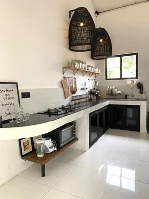 a kitchen with a stove and a counter top at Aesthetic Villa Central Canggu With an Office in Canggu