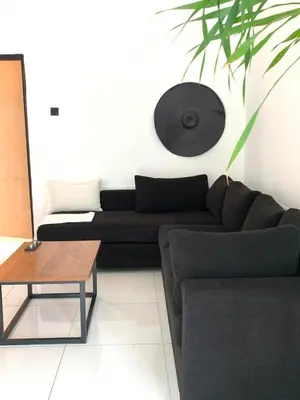 a living room with a couch and a table at Aesthetic Villa Central Canggu With an Office in Canggu